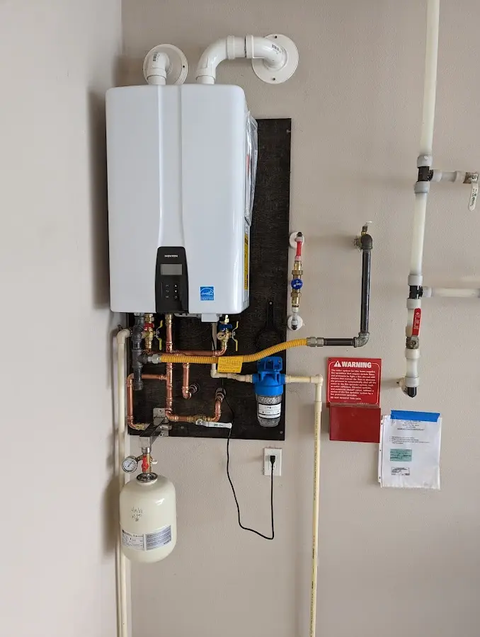 Professional plumber installing copper piping in a Rhinelander home